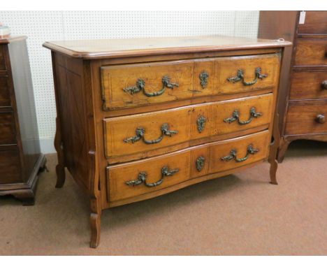 An early Louis XV-period inlaid walnut commode, three drawers, each with elaborate cast rococo handles and escutcheons, top a
