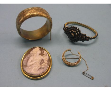 A Victorian yellow metal cameo brooch, Victorian gilt-metal and garnet bracelet, seed-pearl crescent brooch and an engraved g