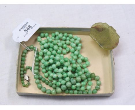 Two jade bead necklaces, and a green-stone amulet with incised script, cracked 
