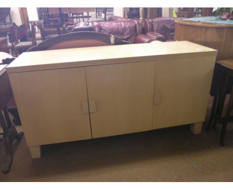 A Kesterport light beech sideboard, shelves and cutlery drawer enclosed by three doors, 5ft. 2in.
