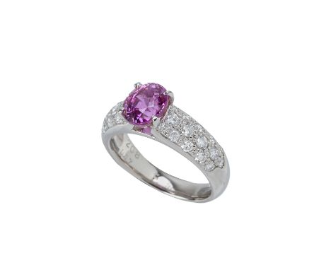 A PURPLE SAPPHIRE AND DIAMOND RING
Set in platinum, the oval cut sapphire flanked by rows of round brilliant cut diamonds to 