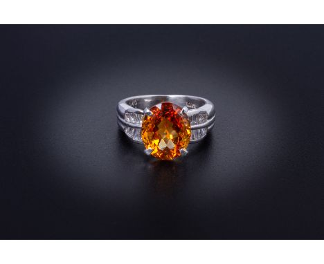 A CITRINE AND DIAMOND RING
Set in platinum, the oval cut citrine flanked by two rows of tapered baguette cut diamonds to each