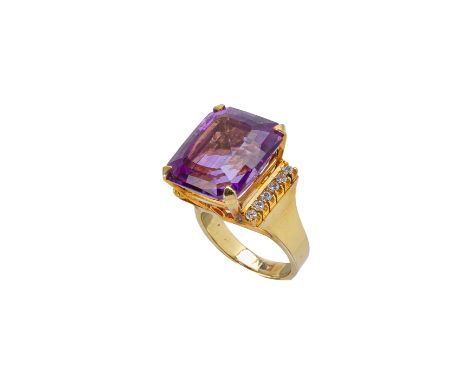 AN AMETHYST AND DIAMOND RING
In 14k yellow gold, the step cut amethyst set in an open gallery and with six round cut diamonds