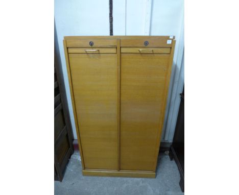 A light oak tambour front office cabinet