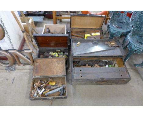 Seven wooden toolboxes all with tools