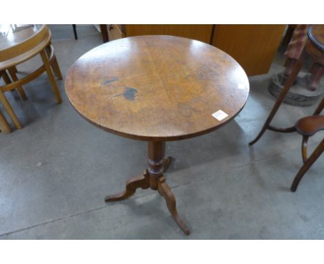 A Victorian oak circular tripod table