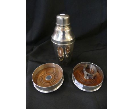 A mixed lot comprising two contemporary silver mounted circular bottle coasters with turned wooden bases, together with a sil