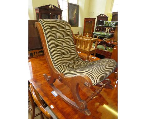A Victorian rocking chair with striped button upholstery 