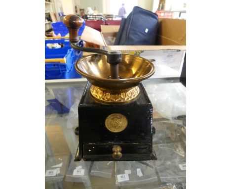 A vintage brass and iron coffee grinder 