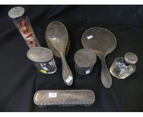 A collection of silver backed dressing table items comprising hand mirror, brushes plus various clear glass jars (7) 