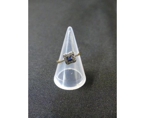 A diamond and sapphire cluster ringThe square shaped sapphire within an old cut diamond surround, stamped 18ct, ring size K, 