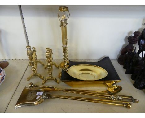 A mixed lot of various brass fire tools, fire dogs, a pair of barley twist candlesticks and other items 