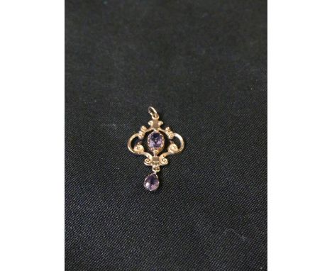 A 9ct gold amethyst pendantThe pear shape amethyst suspended from the oval shape amethyst scrolling panel, hallmarks for Shef