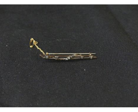 An early 20th Century seed pearl broochOf scrolling design, the seed pearl bar brooch with pointed terminals, AF, length 6.6c