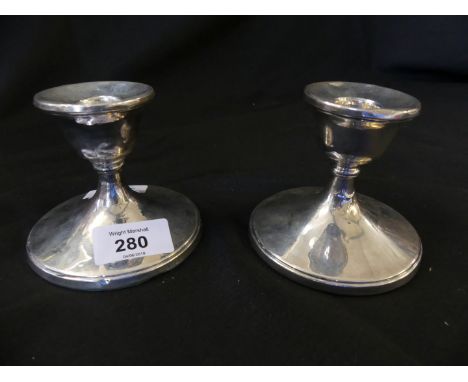 A pair Birmingham hallmarked silver dressing table candlesticks of circular form with loaded bases 