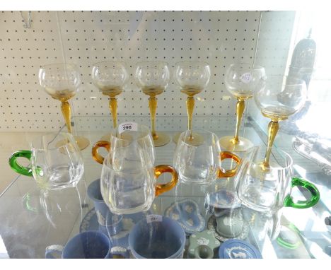 A collection of Art Deco style drinking glasses comprising six wines with amber stems and five various small cups 