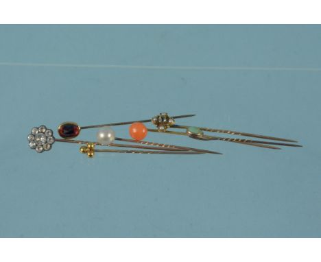 Seven various yellow metal stick pins including coral, pearl and paste set