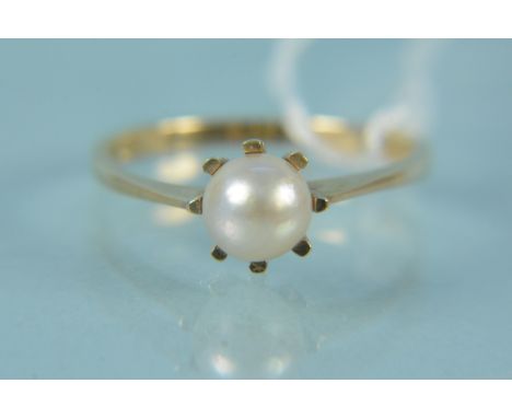 An unmarked yellow metal single pearl set ring, size P, weight approx 2g