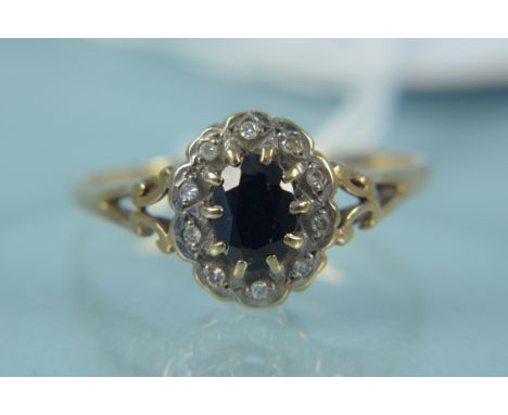 A 9ct gold sapphire and diamond set ring, the centre and claw set stone with diamond border, size Q 1/2, weight approx 2g