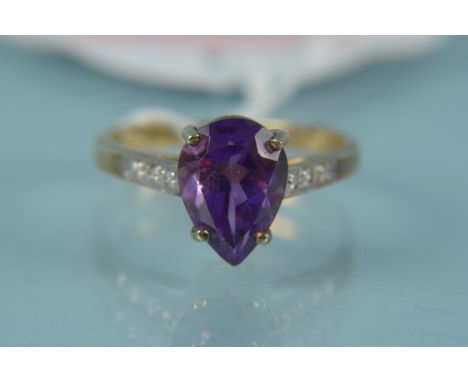 A 9ct gold amethyst and diamond set ring, the four claw pear cut amethyst raised above diamond set shoulders, size N, weight 