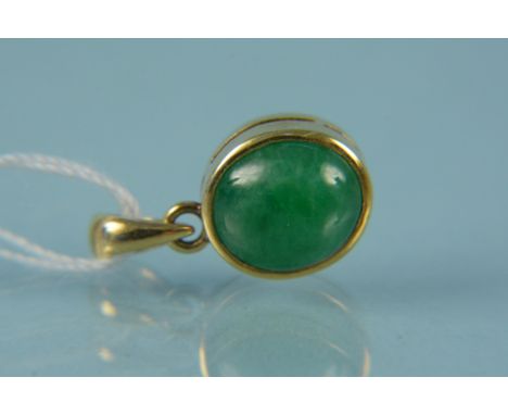 A jade pendant mounted in unmarked yellow metal
