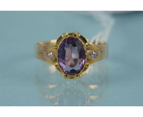 An 18ct gold oval amethyst set ring with diamond set shoulders, shank stamped 18C, size Q 1/2, weight approx 3g