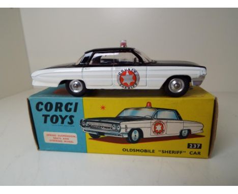 Corgi Toys - Oldsmobile Sheriff Car # 237, black body with cream side panels, red interior with roof light, mint in original 