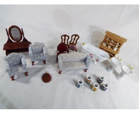 A collection of good quality wooden and ceramic doll's house furniture and accessories.