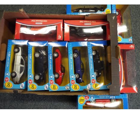 Diecast - A quantity of 11 diecast model motor vehicles in 1:24 scale in original window box, models appear mint.