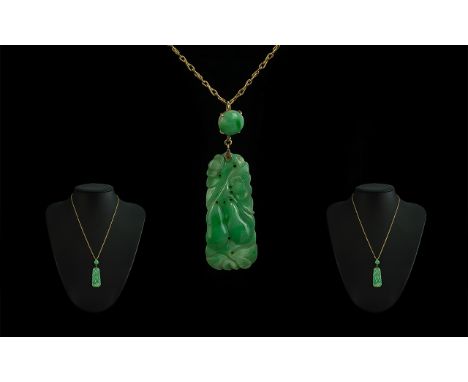 Mid 20th Century 9ct Gold Mounted Jade Pendant attached to a 9ct gold chain, marked 9ct; the jade of excellent colour; length