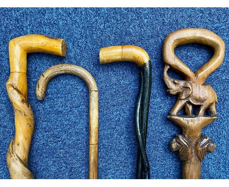 Collection of Wooden Walking Sticks, comprising a slim black twisted wooden stick, and elephant carved stick with twisted bas