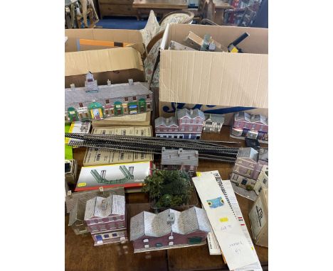 Two Large Boxes Containing a Quantity of Model Railway Station Kits, mostly built, together with track, points, transformers,
