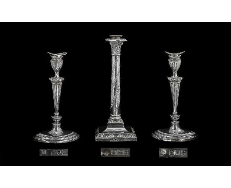 A Pair of Silver Candlesticks, hallmarked for London C 1898.  Plain form on stepped oval base, height 11.5".   Together with 