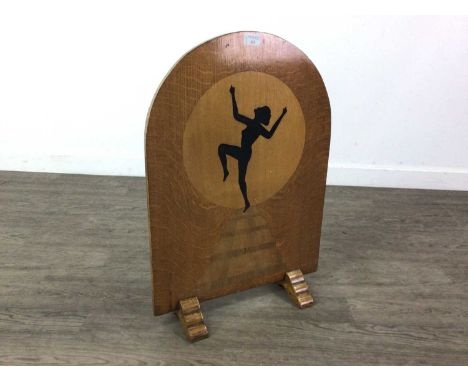 ART DECO OAK FIRESCREEN EARLY 20TH CENTURY with marquetry decoration of a dancer's silhouette, on stepped feet65cm high