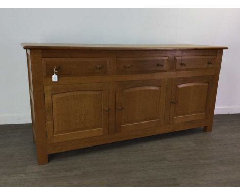 PETER HALL &amp; SON OF STAVELEY, OAK SIDEBOARD LATE 20TH CENTURY with three drawers over three cupboard doors with turned ha