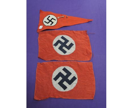 Two small German Swastika flags, 10in x 6in, a German Swastika car pennant approx 12in long plus two stick pins, one of Musso