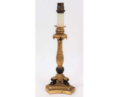 French Empire style ormolu and patinated metal lamp base, with leaf clad stem on three lions paw feet and triangular platform