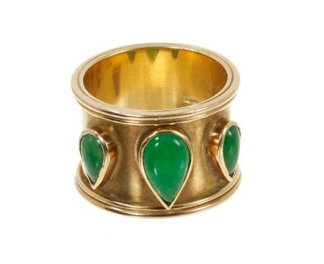 18ct yellow gold and green jade ring, the wide gold band with three pear shape green jade cabochons. Sponsor's mark DJM, Lond