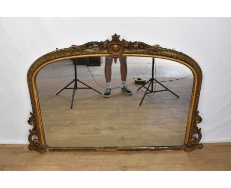 Large Victorian gilt gesso overmantel mirror, arched form with concave frame and pierced cresting, 102 x 152cmProvenance: The
