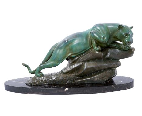 M. Leducq: A patinated spelter model of a panther crouched upon a rock, signed, on oval marble plinth, 60cm longA few small c