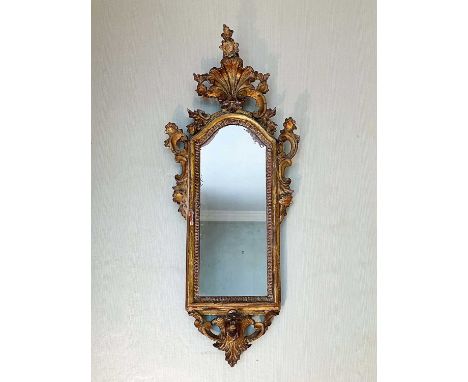 18th century Venetian gilt wood pier mirror, with arched mirrored plate in C-scroll rococo frame with shell surmount, 80 x 33