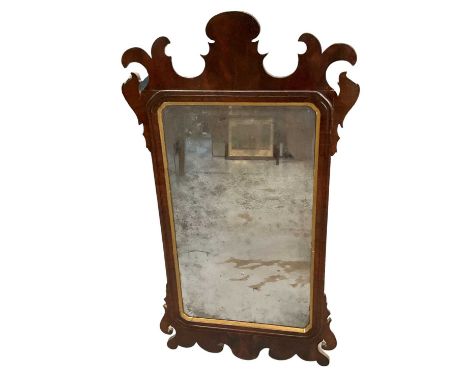 18th century walnut fret carved wall mirror, with bevelled plate in re-entrant slip and fret frame, 92 x 49cmProvenance: The 