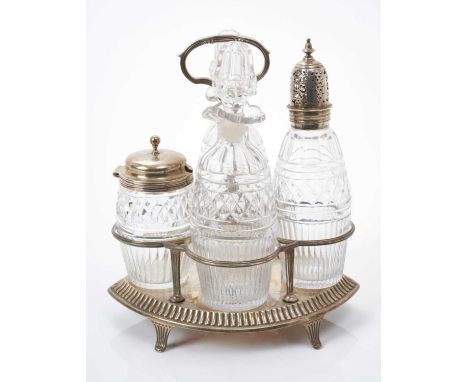 Victorian silver four bottle cruet of elliptical form with reeded frame and central handle, on four scroll feet, together wit