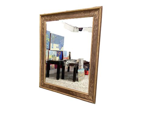 An impressive Edwardian rectangular mirror, of massive proportions, with moulded oak frame painted with foliate gilt borders,