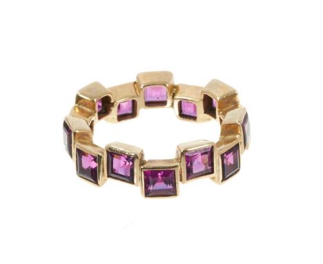 Amethyst and gold eternity ring with a full band of square cut amethysts in abstract gold setting, ring size O.