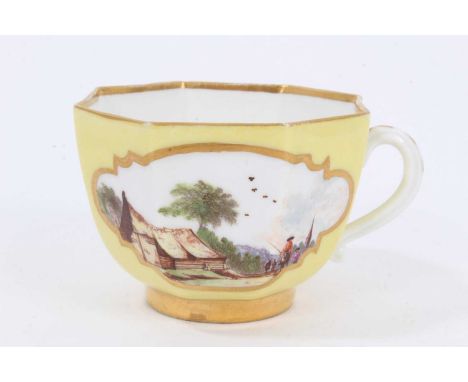 Meissen octagonal teacup, circa 1740, painted with figures in landscapes on a yellow and gilt ground, crossed swords mark to 