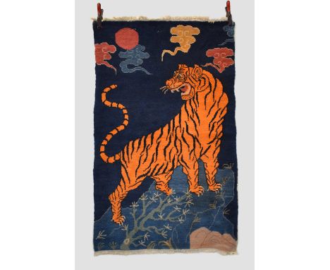 'The Night Watchman'.  Tibetan tiger rug, inner Asia, mid-20th century, 5ft. X 3ft. 1in. 1.52m. X 0.94m.  Small spots of old 