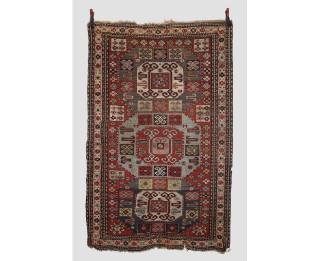 Kazak triple medallion rug, south west Caucasus, early 20th century, 7ft. 3in. X 4ft. 6in. 2.21m. X 1.37m. Overall wear; corr