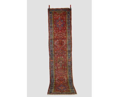 Karaja runner, north west Persia, circa 1930s-40s, 10ft. 5in. X 2ft. 7in. 3.17m. X 0.79m. Slight loss to top end. Light red f