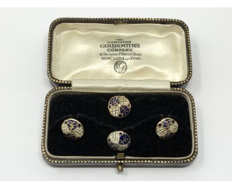 A set of 4 gold white and black enamel studs, 4.25g.